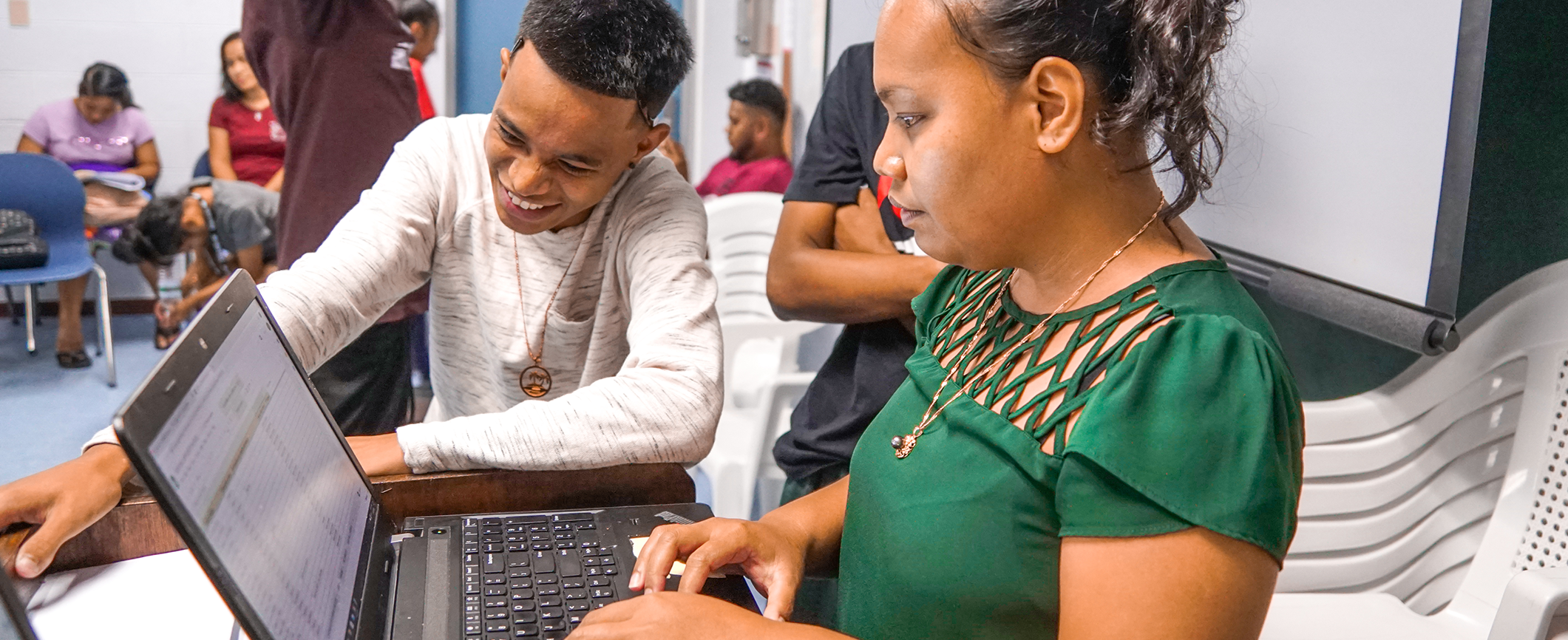 Students working in campus library computer room